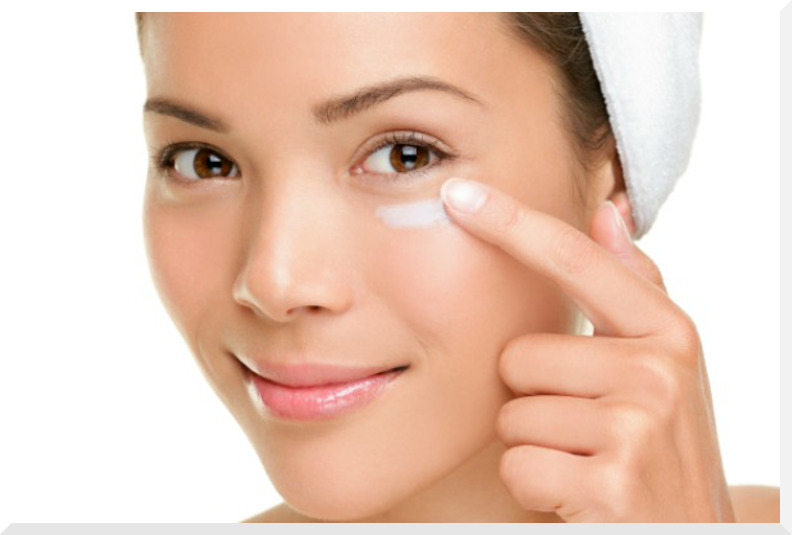 Skin care woman putting face cream