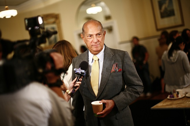 Fashion designer Oscar De La Renta talks to reporters prior to the showing of his Spring 2009 collection during New York Fashion Week