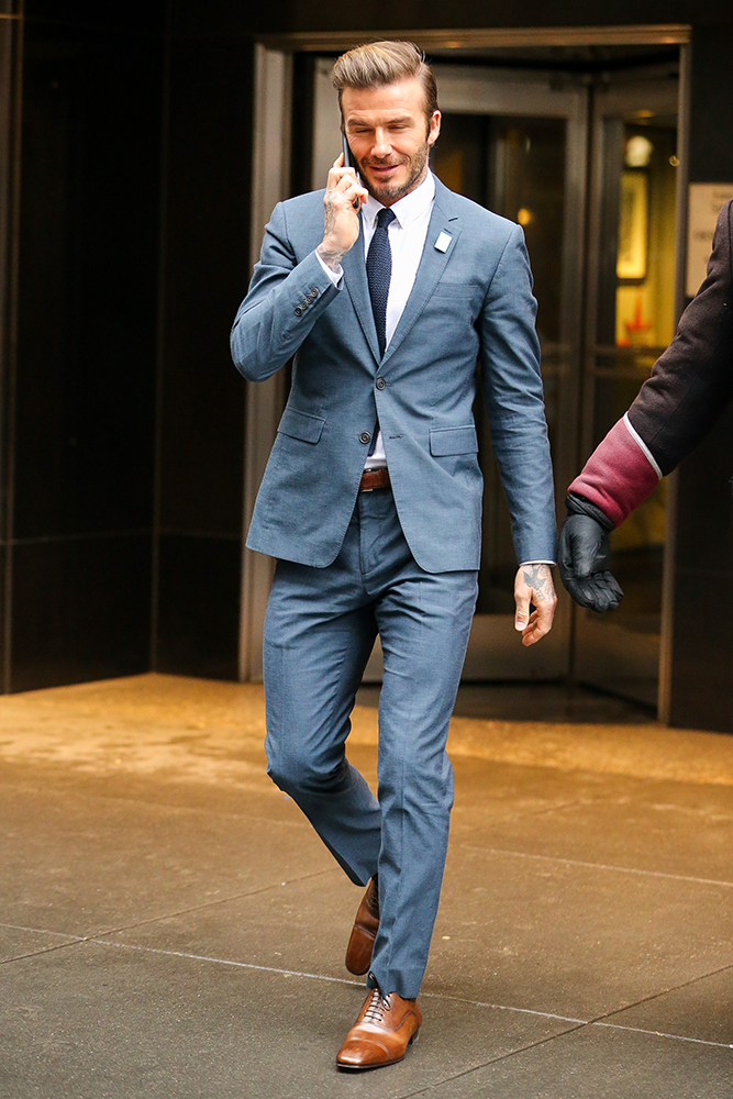 David Beckham chats on his cellphone while leaving the Empire State Building in New York City Pictured: David Beckham Ref: SPL1408452 121216 Picture by: Felipe Ramales / Splash News Splash News and Pictures Los Angeles:310-821-2666 New York:212-619-2666 London:870-934-2666 photodesk@splashnews.com