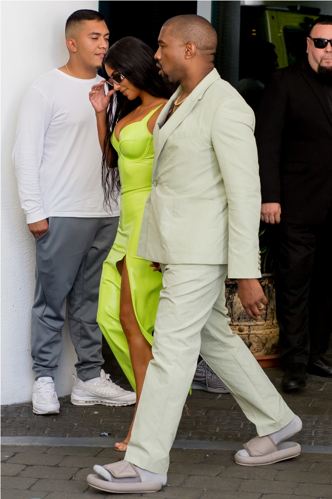 Kim Kardashian turns heads in a neon gown as she and Kanye West arrive at Miami's Versace Mansion for rapper 2Chainz Wedding on Saturday (aug 18). The fashion diva wore a fluorescent yellow gown for the extravagant ceremony, while her hubby bared his chest in a light colored suit. Rapper 2 Chainz was tying the knot with fiancee Kesha Ward at Gianni Versace's famed Casa Casuarina on Ocean Drive. The celebrity arrivals caused a major buzz for tourists who stopped to snap photos. *Dress ? Atsuko Kudo - ?375 *Shoes ? Manolo Blahnik *Sunglasses ? Dior x Rihanna Pictured: Kim Kardashian,Kanye West Ref: SPL5016965 180818 NON-EXCLUSIVE Picture by: AM/Brian Prahl/Splash News / SplashNews.com Splash News and Pictures Los Angeles: 310-821-2666 New York: 212-619-2666 London: 0207 644 7656 Milan: +39 02 4399 8577 Sydney: +61 02 9240 7700 photodesk@splashnews.com World Rights