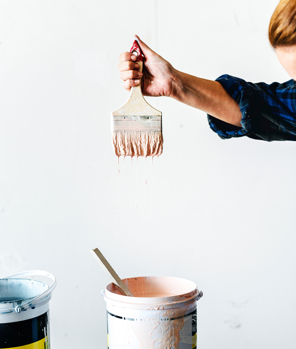 Χέρι κρατά βούρτσα για βάψιμο τοίχου