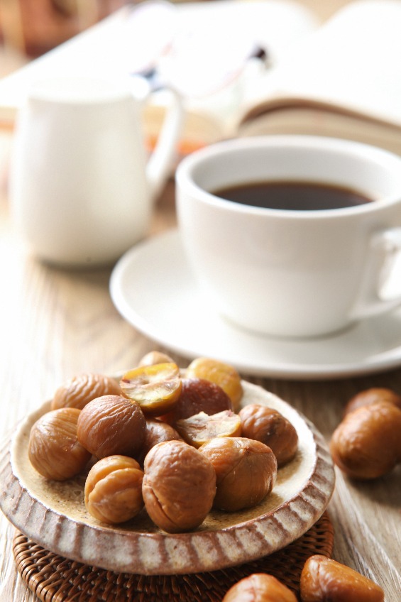 peeled chestnuts on round plate, and a cup of coffee
