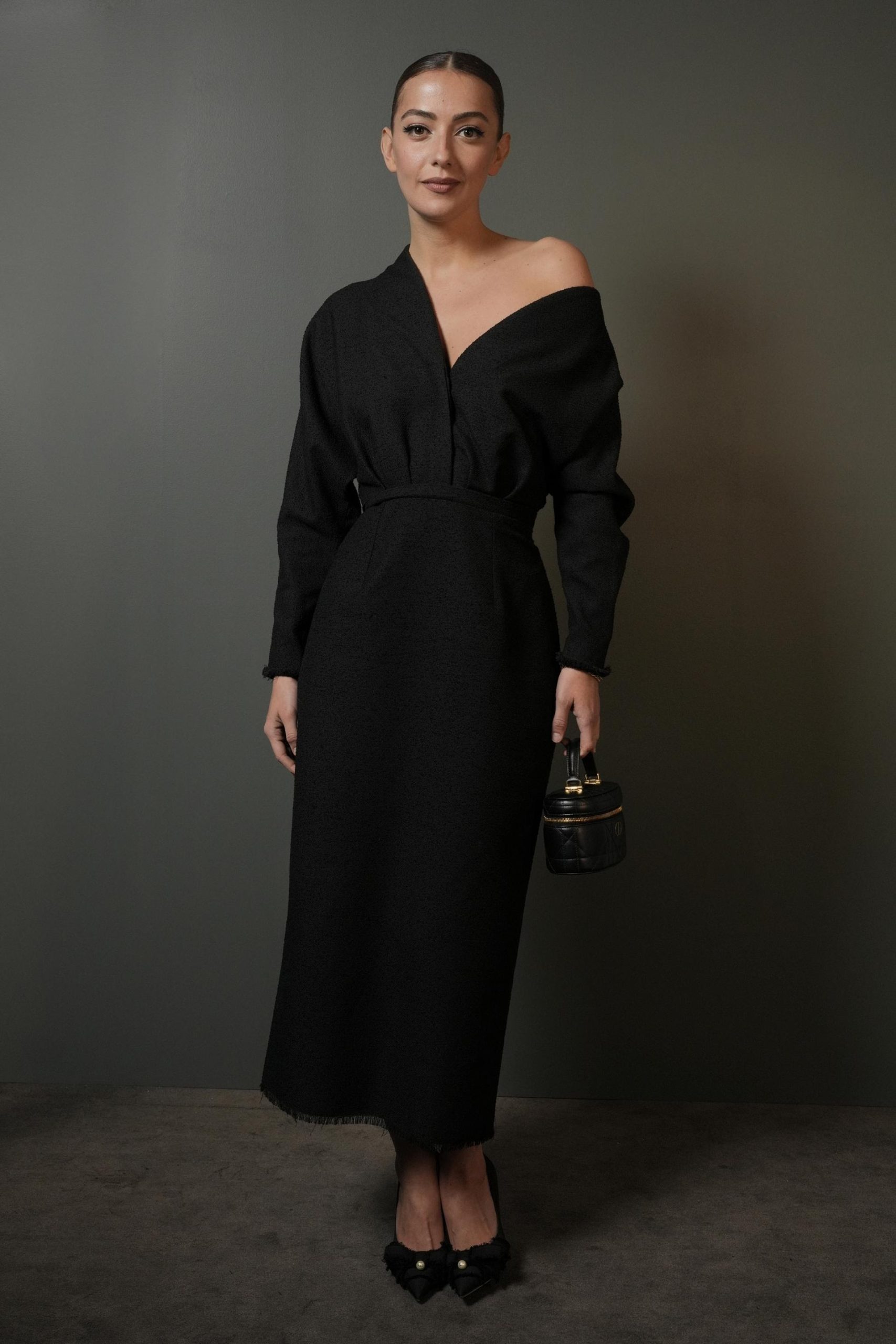 Η Claire Deroo φόρεσε μια ασύμμετρη βαμβακερή μπλούζα Dior με μια μαύρη μάλλινη φούστα. Φορούσε επίσης τσάντα και παπούτσια Dior.