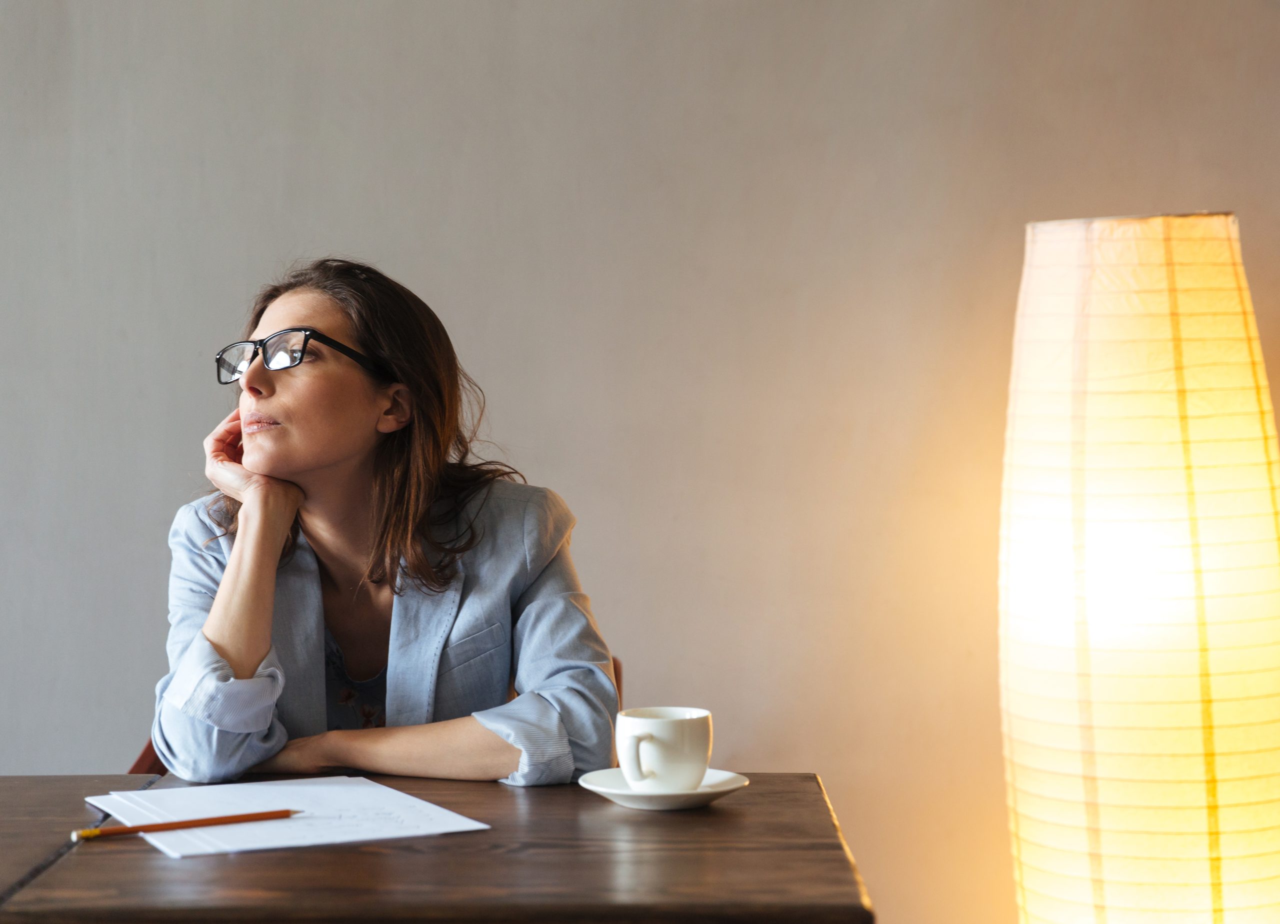 Γυναίκα σκέφτεται και κρατάει σημειώσεις
