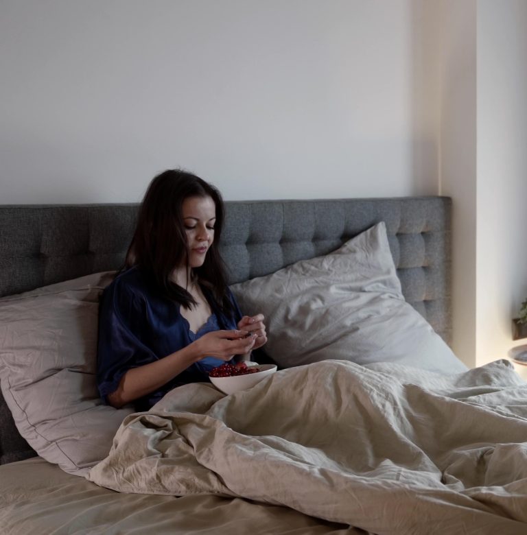 Γυναίκα στο κρεβάτι τρώει