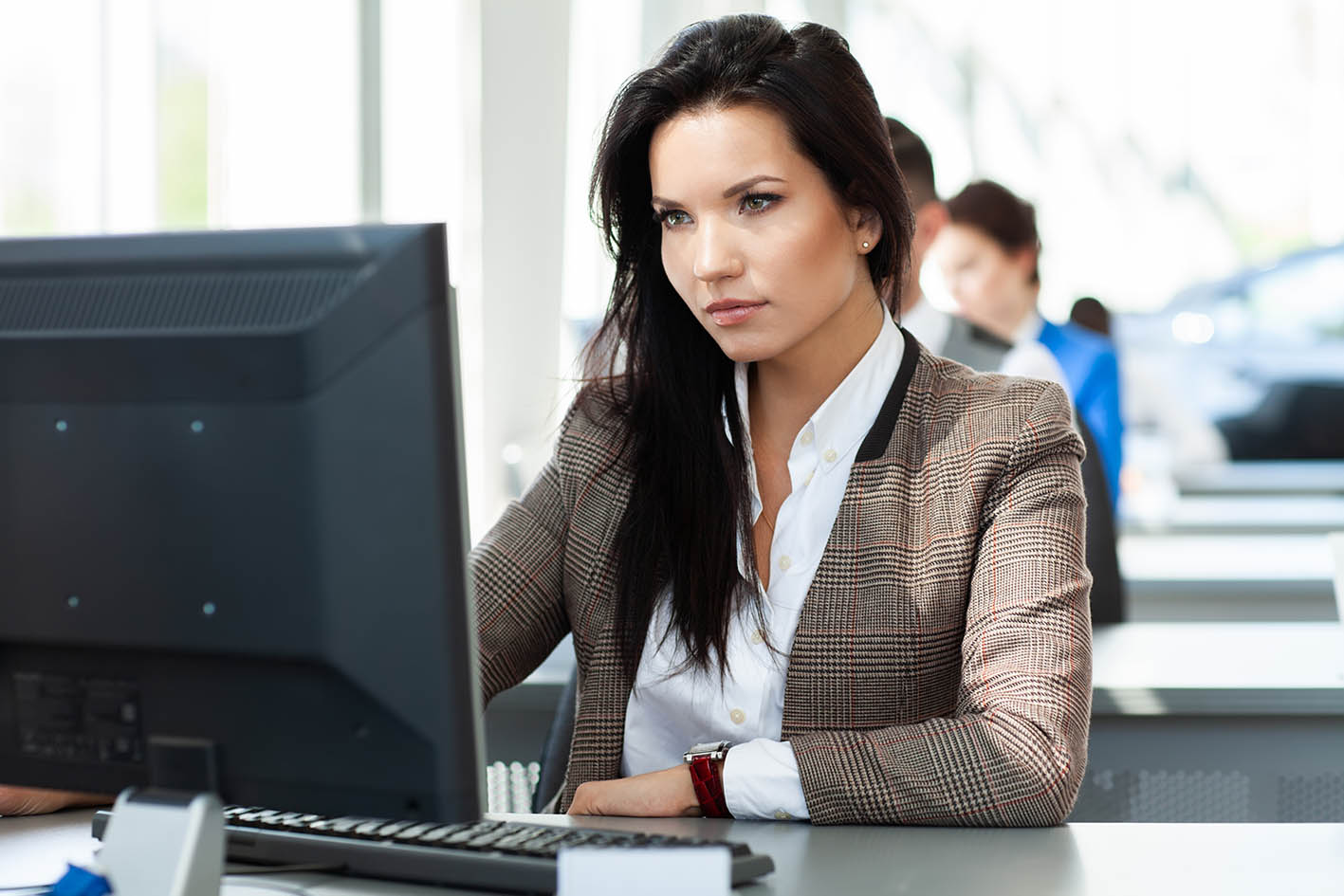 Γυναίκα εργάζεται μπροστά στην οθόνη του κομπιούτερ της