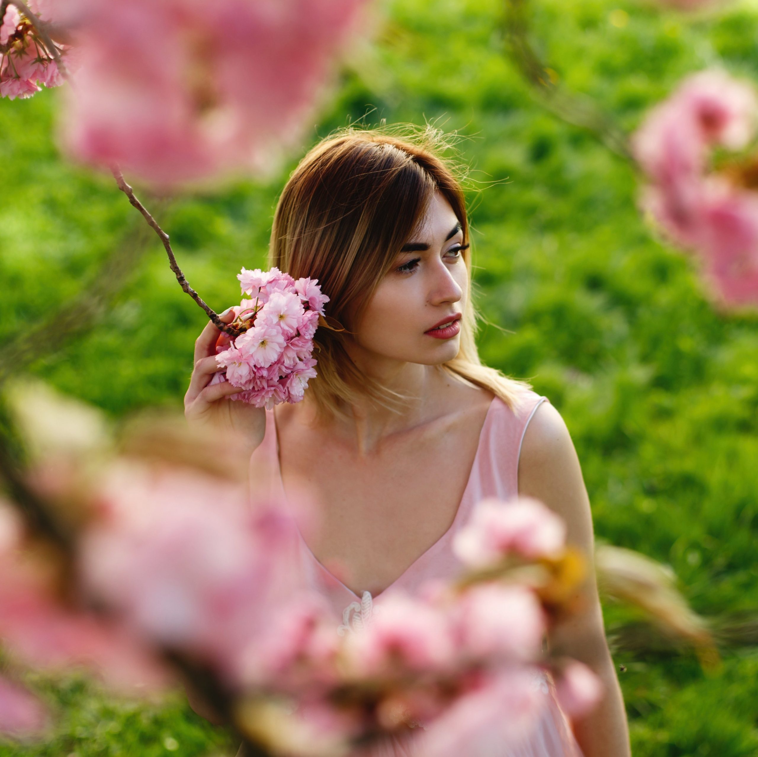 Γυναίκα σκεπτική ανάμεσα σε λουλούδια