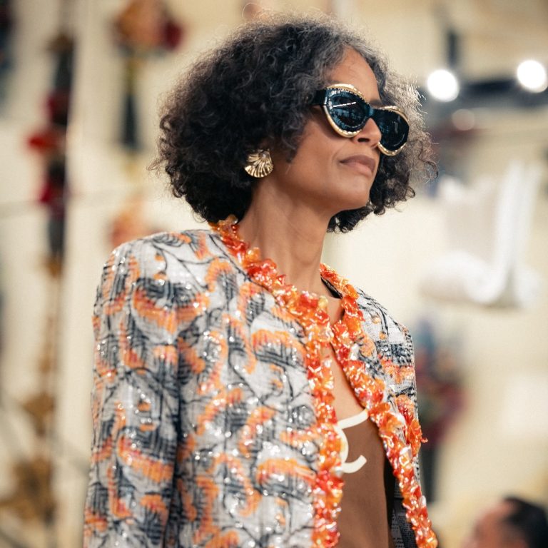 Look από Chanel cruise 26/27 με ένα σακάκι με κοραλί και μπλε λεπτομέρειες.