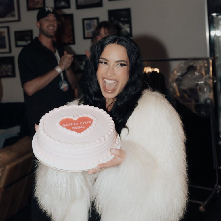 H Demi Lovato με μια τούρτα και μια λευκή γούνα.