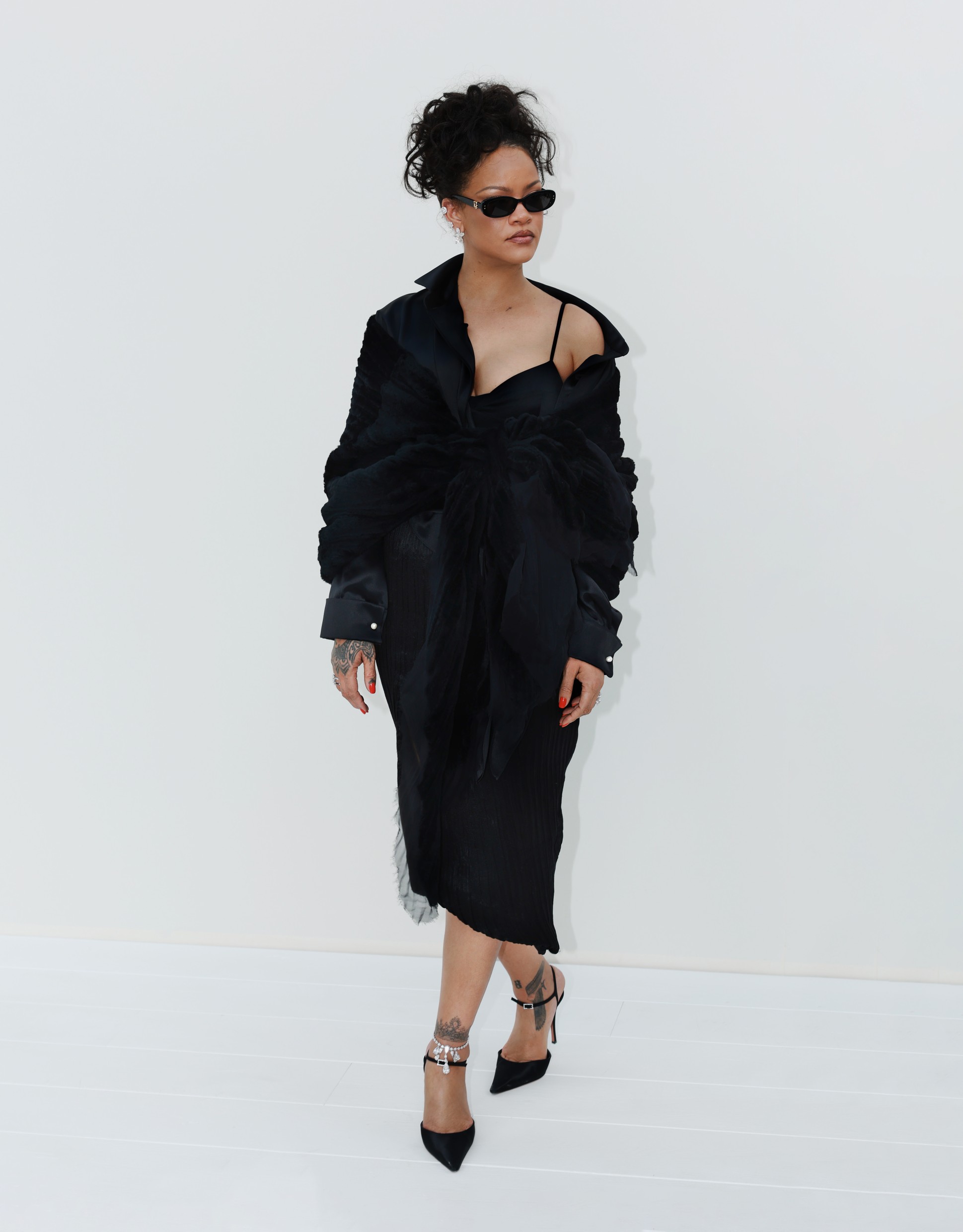Η Rihanna εμφανίστηκε στο show με μαύρο Dior σύνολο, σε μια εμφάνιση πολύ διαφορετική από το μπρονζέ σύνολο με το οποίο είχε κάνει νωρίτερα την εμφάνισή της στην Paris Fashion Week.