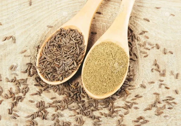 78646699-ground-cumin-in-a-spoon-and-whole-cumin-on-the-wooden-background