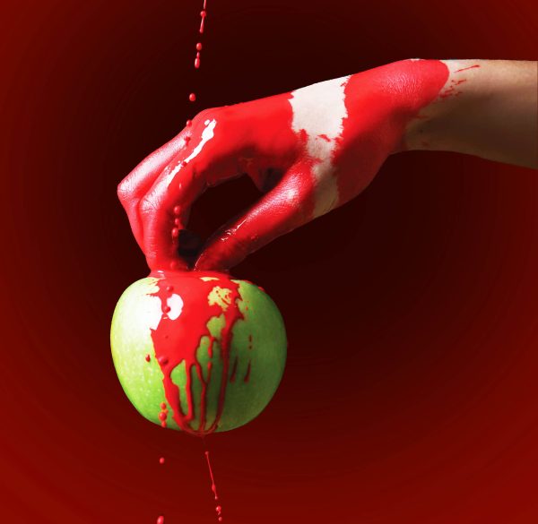 Painted,Hand,With,Apple,Against,Dark,Background