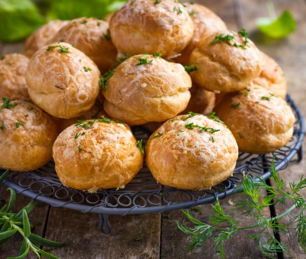 Gougeres. Traditional french cheese choux buns. wooden background.