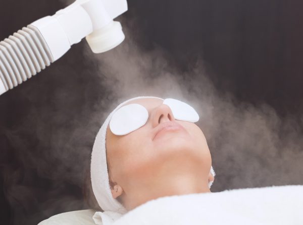 The procedure of steaming the skin of the face of a young woman