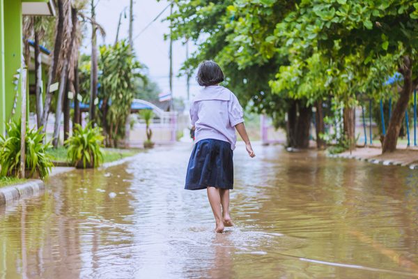 happy girl walking to flood in school