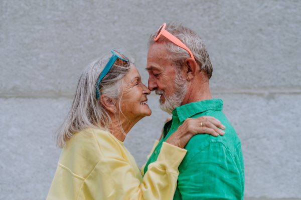 Portrait of happy senior couple in love in colourful clothes.