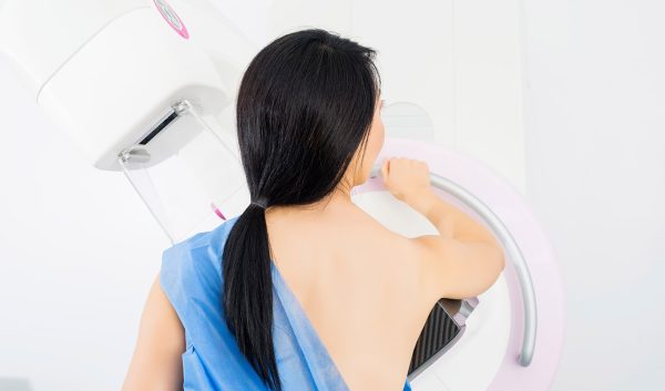 Woman Undergoing Mammogram X-ray Test In Clinic