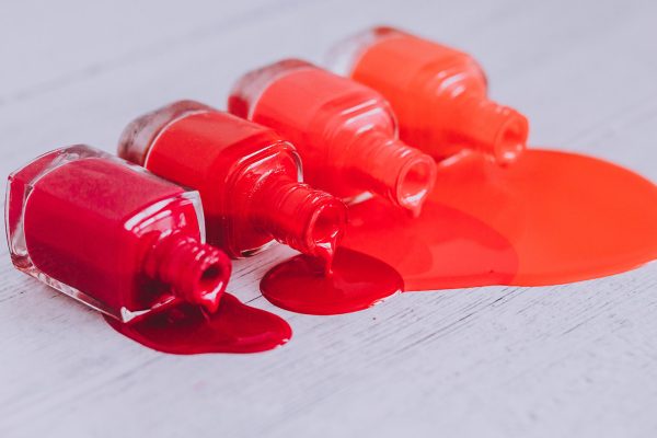nail polish bottles in different shades of red to orange and pur