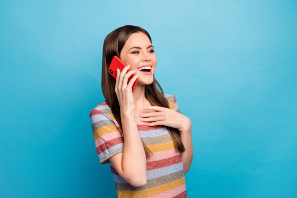 Close-up portrait of her she nice lovely pretty charming positive cheerful cheery girl using cell calling friend talking isolated over bright vivid shine vibrant blue color background
