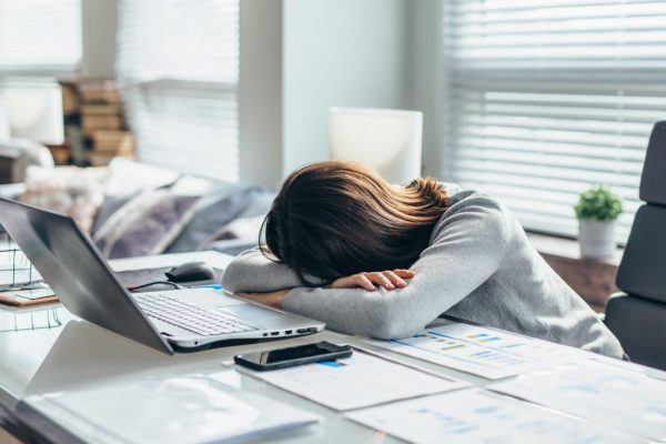 Woman in workplace is resting, tired of work