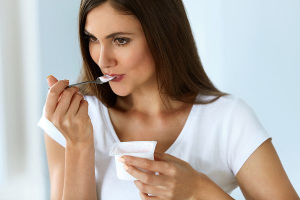 Healthy Nutrition. Beautiful Woman Eating Yogurt, Dairy Product