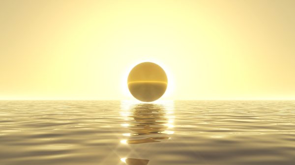 heavenly sunrise on golden sea with golden ball on front of sun.
